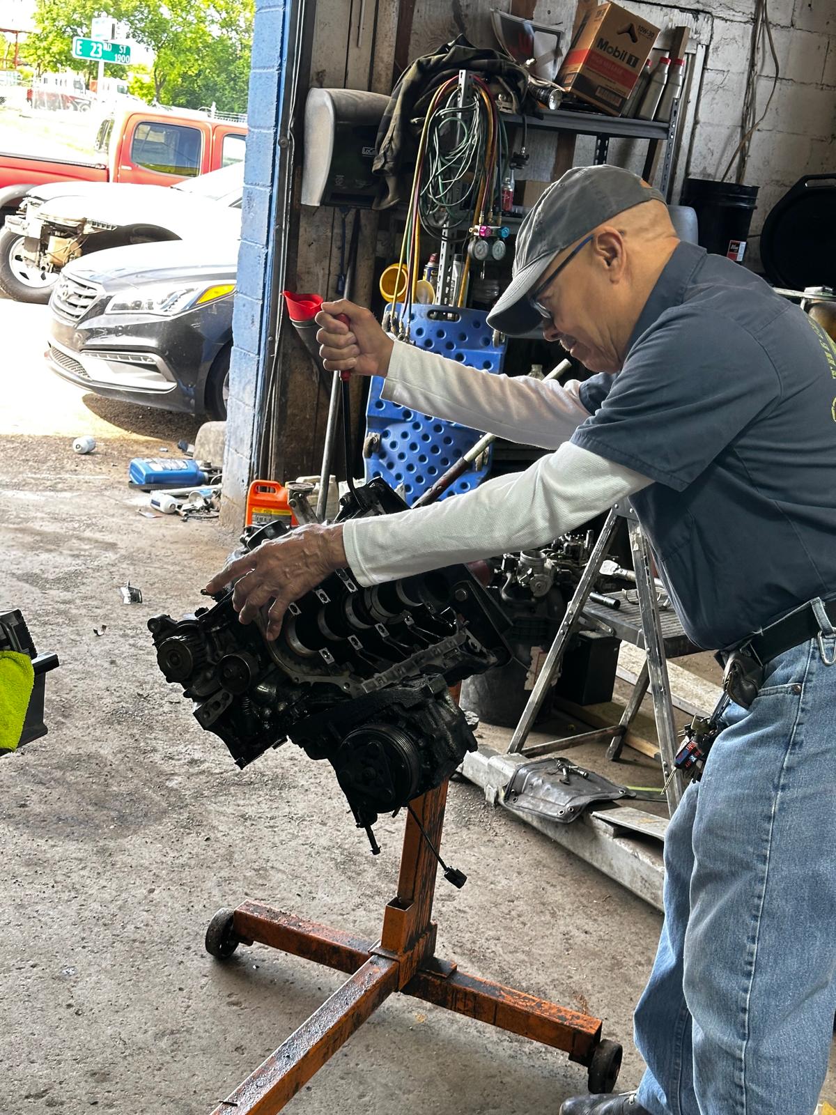 Mechanic working on a rebuilt engine at Jr Tire Shop